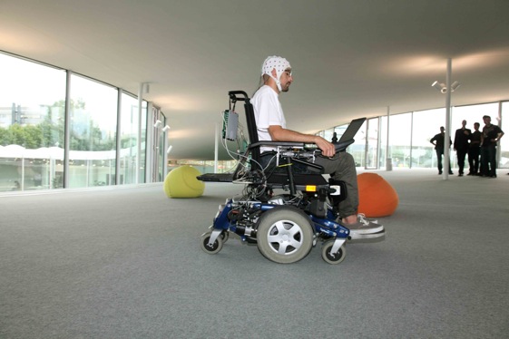 Man using laptop in motorized wheelchair 561*374